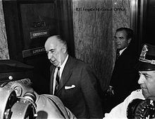 Former Attorney General Mitchell enters the Senate caucus room to ...