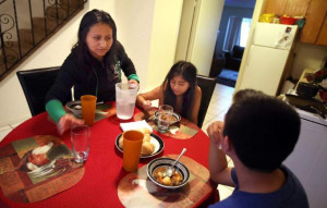 Josefina Velasquez, left, serves dinner to her two children, Maria ...