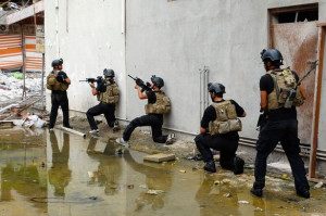 Members of the Iraqi Special Operations Forces take positions during a ...