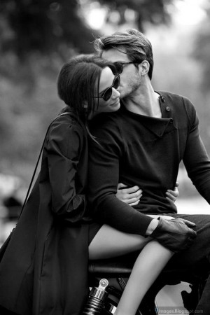Kiss couple sunglasses on bike black and white