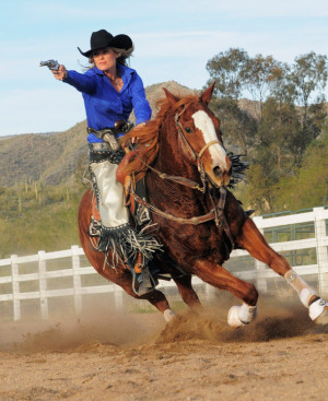 With six guns a blazing, Kenda Lenseigne puts her horse through its ...