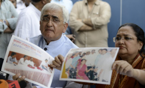 Salman Khurshid left and wife Louise produce pictures and documents