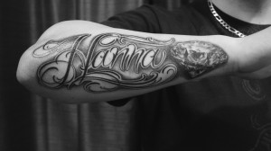 Forearm black and grey custom script tattoo