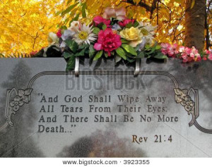 ... of Silk flowers on a cemetery grave tombstone revelations bible verse