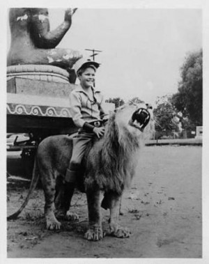 Circus Boy riding a lion