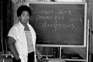 Audre Lorde lecturing, words on blackboard are Women are powerful and ...