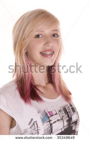 Pretty teenage girl with blonde and pink hair, wearing dental braces ...