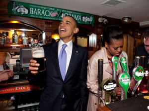 President Obama talks with pub-goers as First Lady Michelle Obama ...