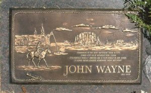 ... featuring an image of John Wayne astride a horse, near the Alamo