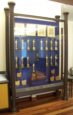 large cabinet containing several golden statuettes and a few ...