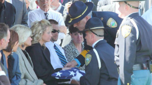 Sedgwick County Sheriff Bob Hinshaw presents the flag that covered the