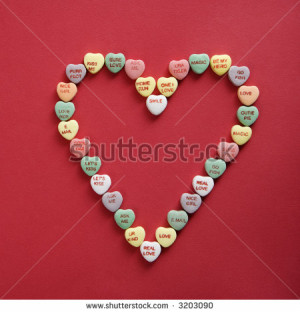 Colorful candy hearts with sayings on them arranged in shape of heart ...
