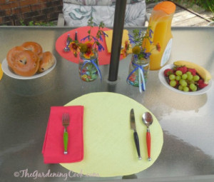 Multi colored cutlery, napkins and rattan place mats compliment the ...