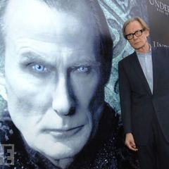 Bill Nighy in front of a large poster of himself as Viktor.