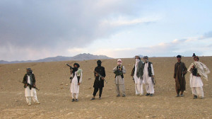 Taliban fighters stand on a hillside at Maydan Shahr