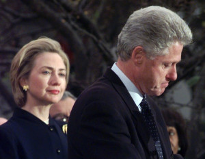 First Lady Hillary Rodham Clinton watches President Clinton pause as ...