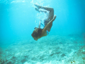 She would be half a planet away, floating in a turquoise sea, dancing ...