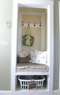 this front entry nook with hooks and bench is in a CLOSET with the ...