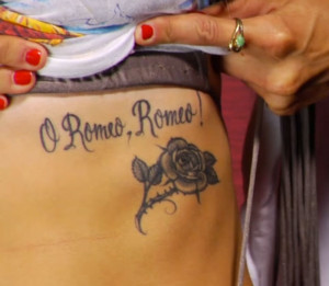 Beneath her left breast is a rose with thorns and the words “O Romeo ...