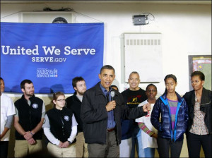 Obama and daughter Malia, speaks while participating in a community ...