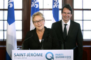 Parti Quebecois leader Pauline Marois (L) smiles after introducing her ...