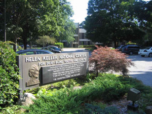 Main entrance to HKNC with Helen Keller quote - While they were saying ...