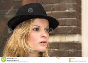 Haired Woman With Black Trilby Style Hat Brick Wall Background