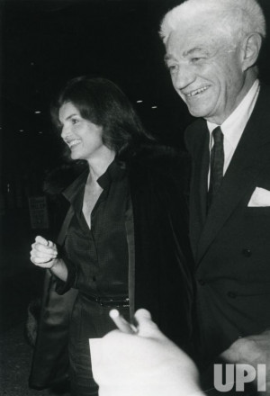 Jacqueline Kennedy Onassis and designer Oliver Smith walk to a theater ...
