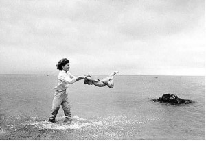 Mark Shaw, Jacqueline Kennedy swinging Caroline in surf, Hyannis Port ...