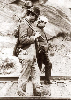 Two hobos walking along railroad tracks, after being put off a train