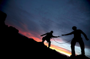 Climber Reaching Out to Help His Partner - Photo courtesy of ...
