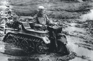 German soldier fords through a flooded area on his Sd.Kfz. 2 tracked ...