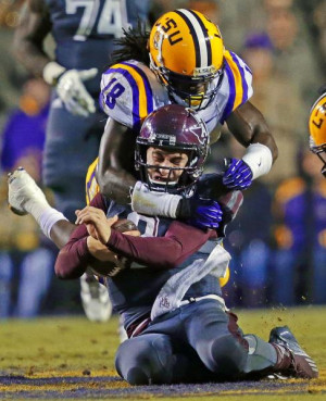 Texas A&M quarterback Johnny Manziel is tackled by LSU linebacker ...