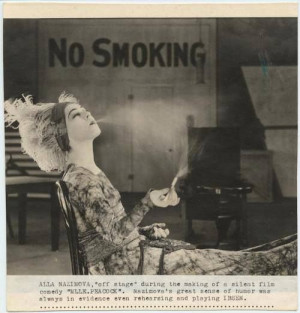 Alla Nazimova takes a smoke break during the filming of Mlle Peacock ...