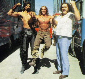Arnold Schwarzenegger looking like a small child in the arms of Wilt ...