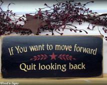 Inspirational wooden sign, If you w ant to move forward quit looking ...