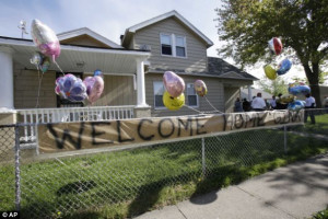 Celebration: A 'Welcome Home Gina' sign hangs on a fence outside the ...