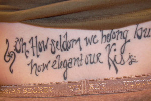 lower back tattoo phrase tattoo an arc shaped lettering tattoo