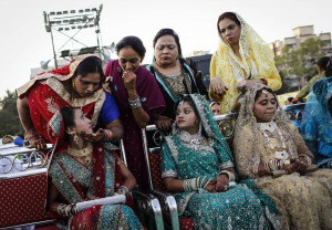 ... relative as they wait for start of mass marriage ceremony in Mumbai