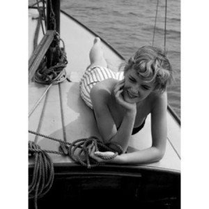 Woman relaxing on deck of boat Poster Print (18 x 24)