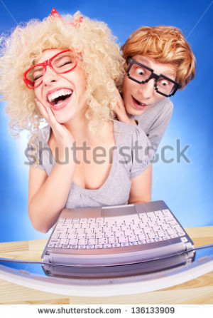 Funny couple using laptop computer - stock photo