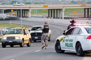 Image: Military police direct traffic outside Fort Hood military base
