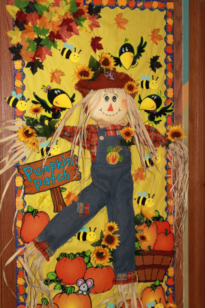 Fall bulletin board. Love the idea to incorporate a real scarecrow ...