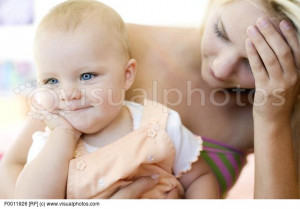 MODEL RELEASED. Teenage mother and baby. Stressed young mother holding ...