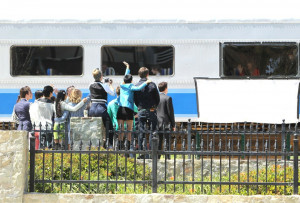 New Directions waving goodbye to Rachel as she leaves the station.