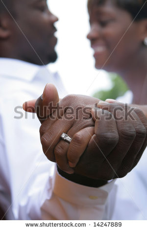 An african american couple in love. Shallow dof, focus is on hands