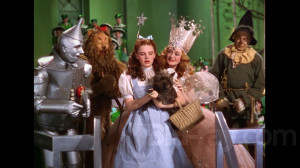 Dorothy and Toto are consoled by Glinda the Good Witch of the South