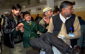 peshawar school attack pakistani volunteers carry a student injured in ...