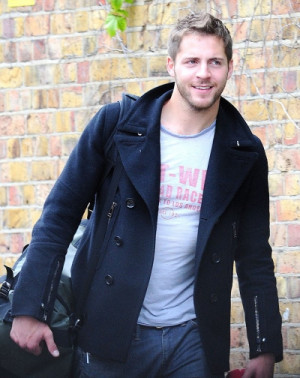 The handsome man was dressed casually in a black pea coat that he ...