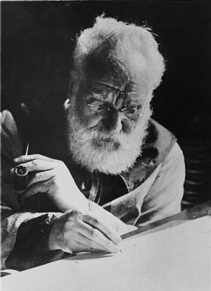 Alexander Graham Bell writing at his desk in his study in Washington ...